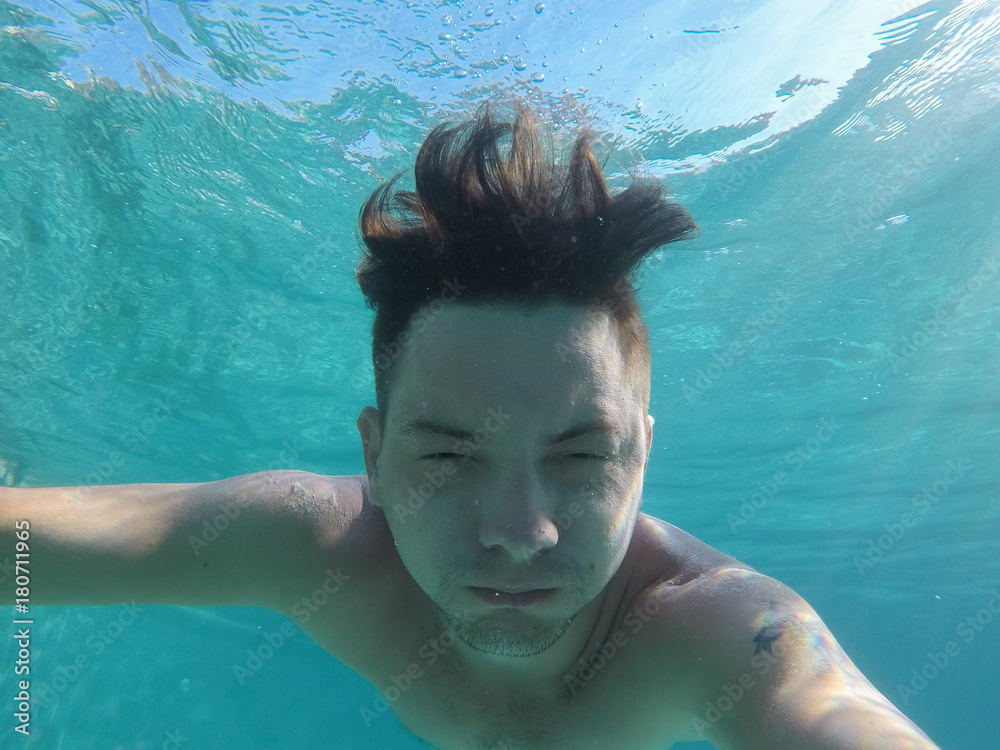 A man is engaged in scuba diving in the sea A man is engaged in scuba diving in the sea