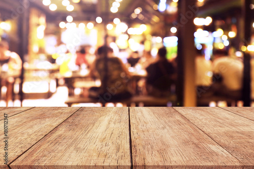 Wood table top with blurred light cafe or restaurant background  © Thanakorn Thaneevej
