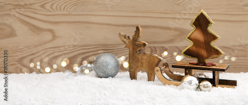 Christmas background with wood deer and fir-tree on sledge.