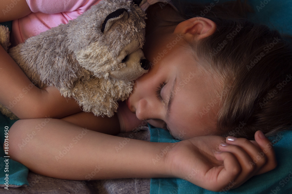 Little blond child sleeping in his bed with toy. Little blond child sleeping in his bed with toy.