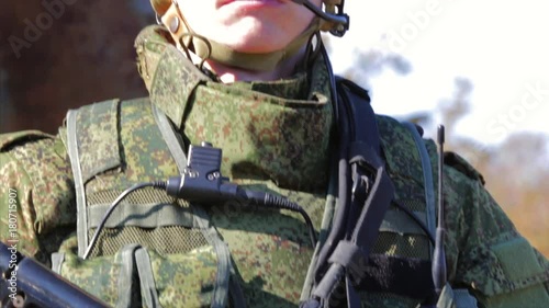 Soldier with automatic rifle. Closeup. Front view photo