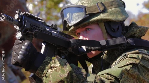 Soldier near old rusty AAA gun. Search and destroy operation. photo