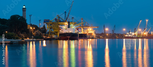 Photography commercial ships in the harbor at night panorama
