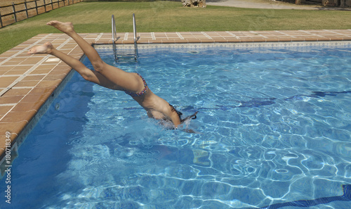 Woman jumping in the pool