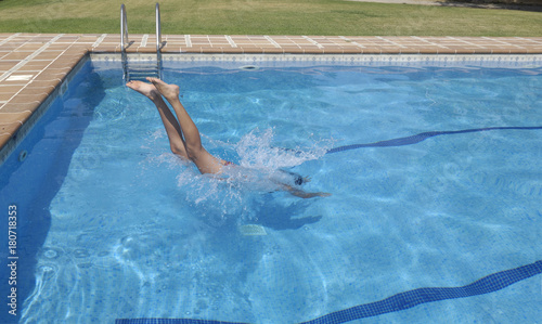 Woman jumping in the pool