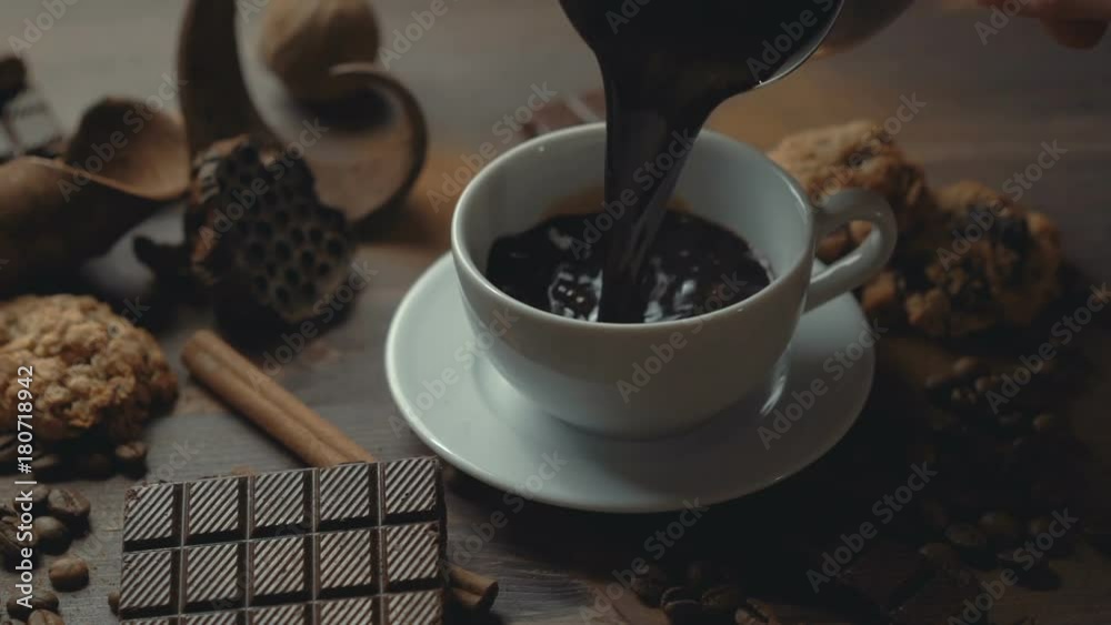 cup of coffee cinnamon sticks and anise star on old wooden table.