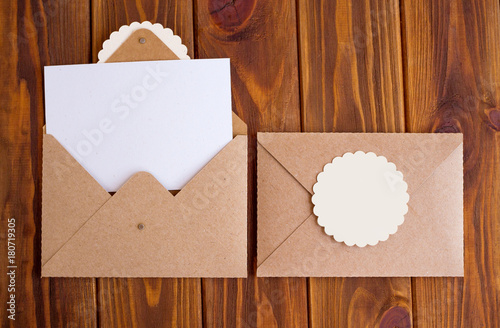 Letter from kraft paper for writing on a wooden background 