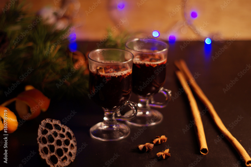 glasses for mulled wine, Hot Holiday mulled wine, winter hot drink, warming, New Year's background, mulled wine against a background of dried flowers, cotton, spruce branches