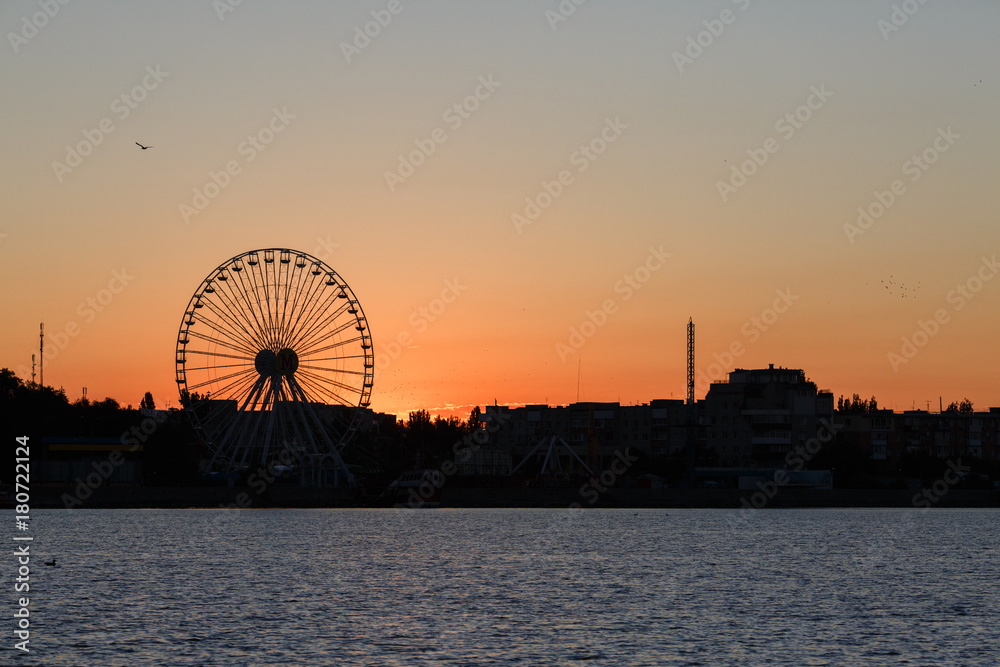 Ferris wheel on the background of sunrise, Berdyansk city, Ukraine