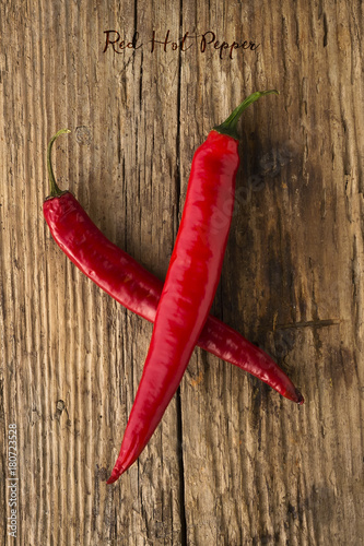 Red hot pepper on a wooden background. Spice. Food background.