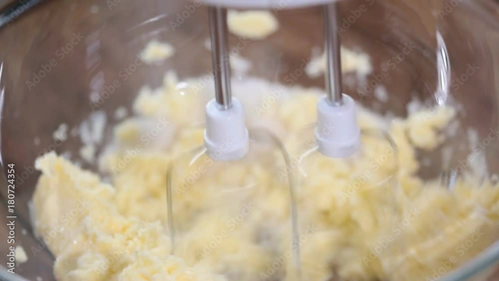 Woman beating with a mixer butter c sugar