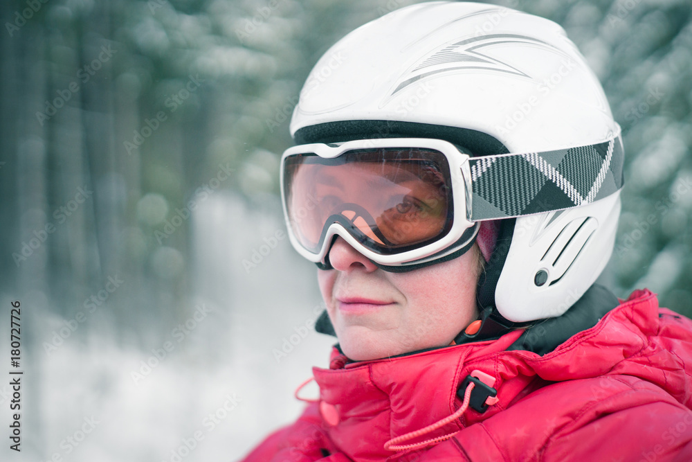 Woman skier in mask and helmet on lift. Woman skier in mask and helmet on lift.