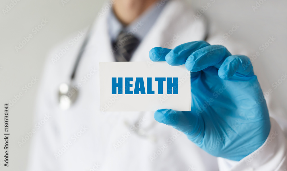 Doctor holding a card with text HEALTH, medical concept Doctor holding a card with text HEALTH, medical concept