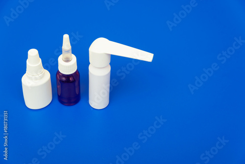 Medications, pills and a thermometer on a bright background