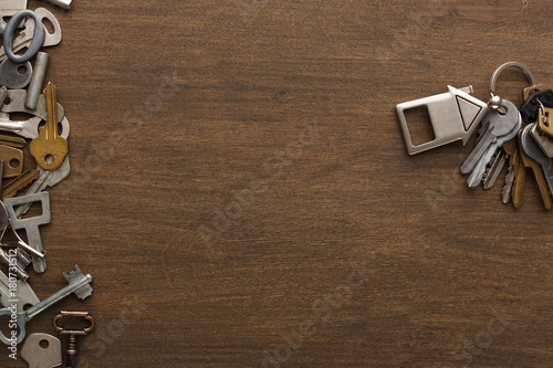 Bunch of keys with house trinklet on wooden table