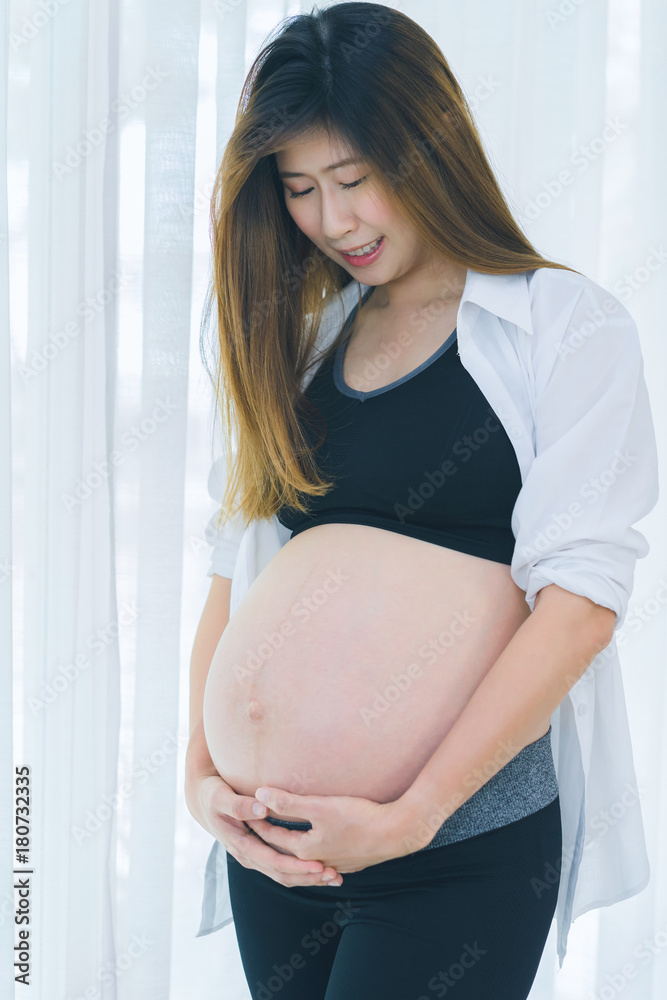 Beautiful pregnant woman touching care her belly Beautiful pregnant woman touching care her belly