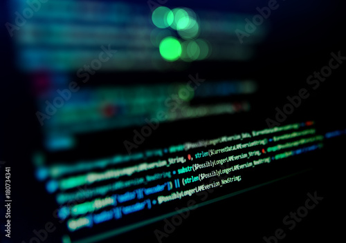 Screen with software developer code. Blur lights.