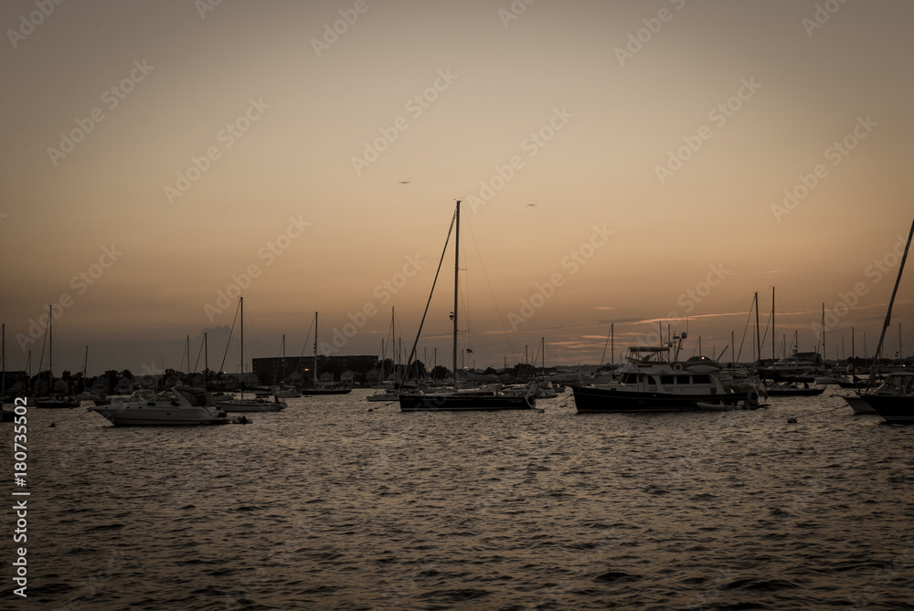 Sail boats docked with sea ocean background. Maritime boats docked with sunset colorful clouds.