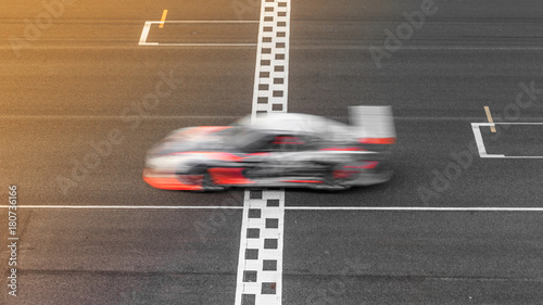 Canvas Print Motion Blur race car racing on speed track, Super car race on the international race track crossing start and finish line with motion blur, Automobile and automotive transportation vehicle background
