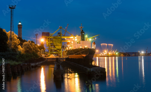 commercial ships in the harbor at night panorama