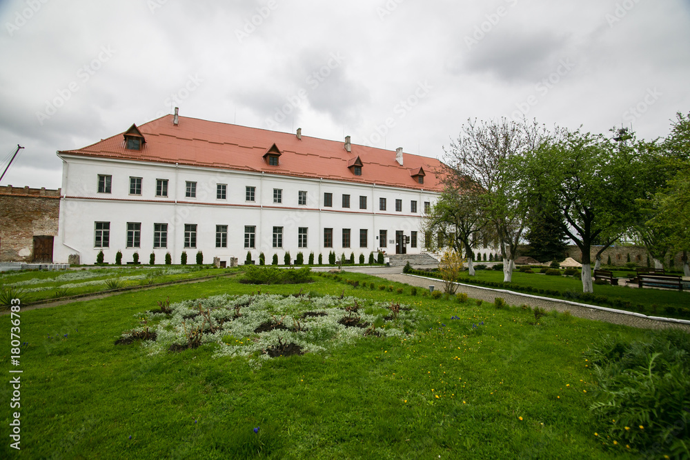 Well-preserved old building with garden and green alley at the Dubno