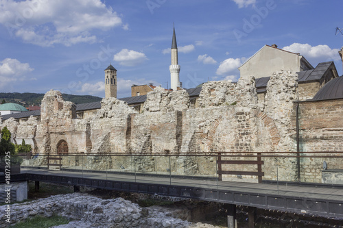 Ruins of Taslinan caravanserai in Sarajevo, with Gazi Husrev Beh Mosque minaret in the background photo