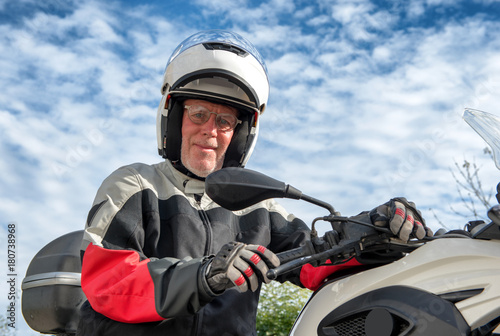 portrait of a senior biker on his motorcycle