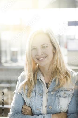 Free Download modern young business woman in casual look in front of glass building - GFXLoad