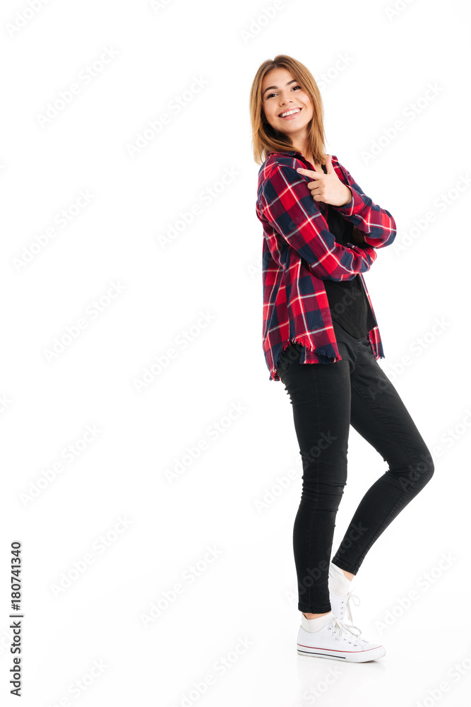Smiling young woman pointing to copyspace. Smiling young woman pointing to copyspace.