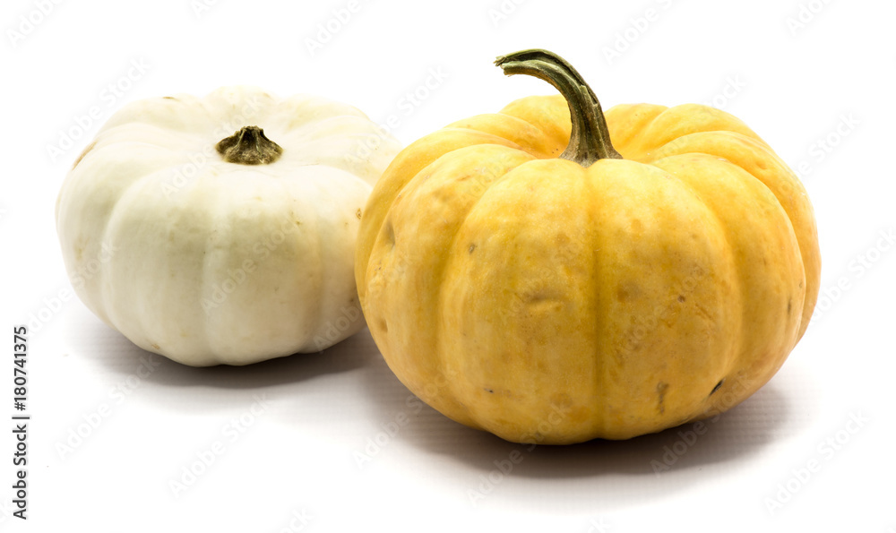Two whole colorful pumpkins (yellow, white) isolated on white background.