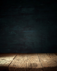 Old wood table top with smoke in the dark background.
