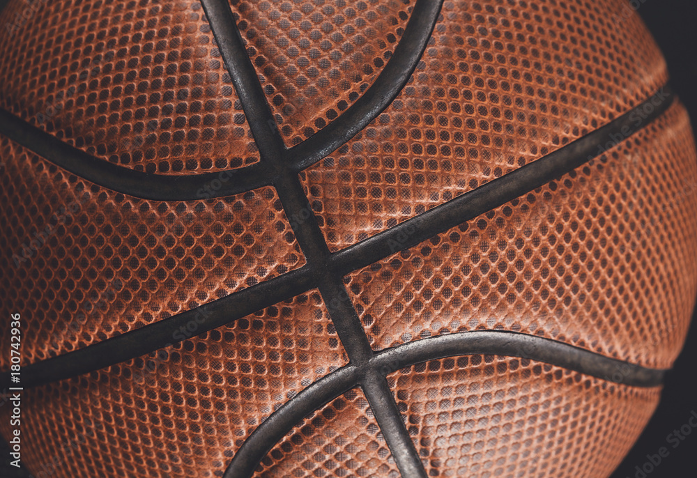 Obraz premium Old basketball ball on black background closeup
