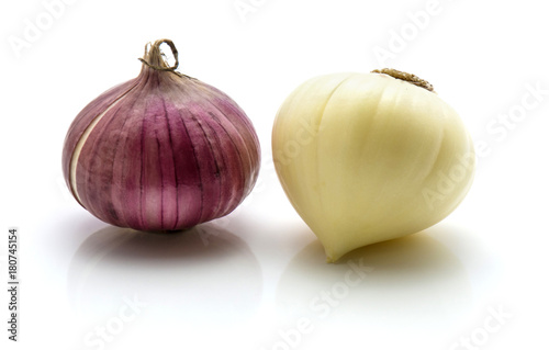 Two bulbs of solo garlic isolated on white background one bulb peeled one whole.