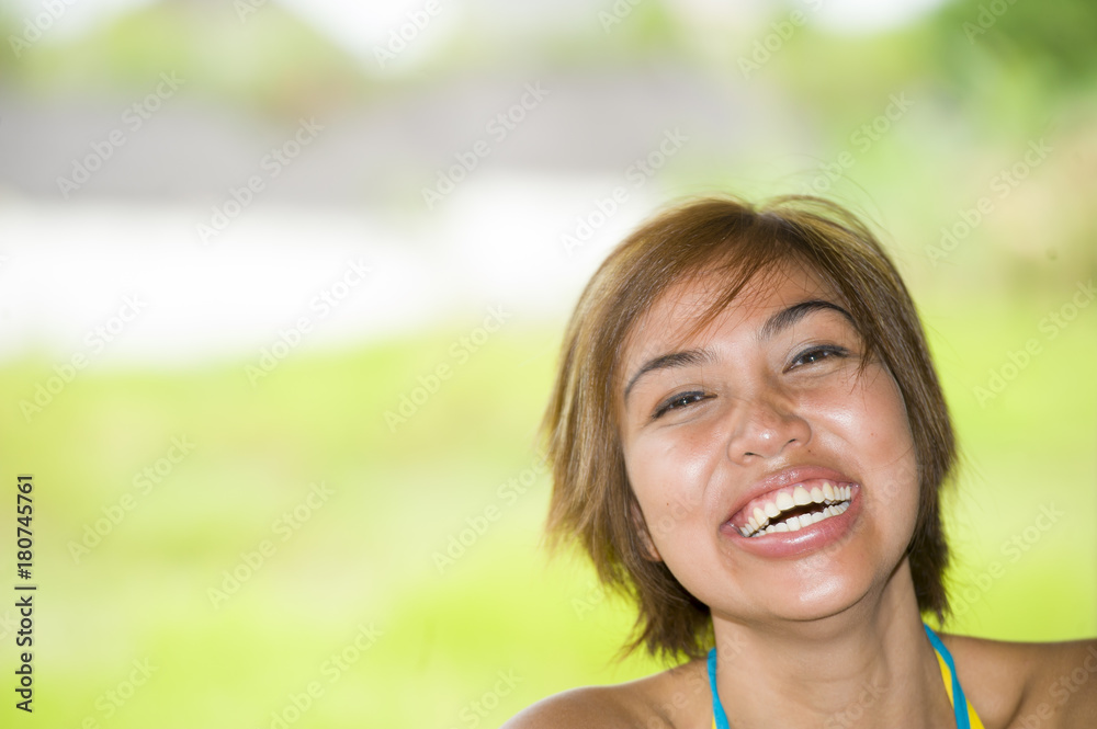 close up portrait of young happy and beautiful expressive Asian woman laughing excited and nice in positive face expression close up portrait of young happy and beautiful expressive Asian woman laughing excited and nice in positive face expression
