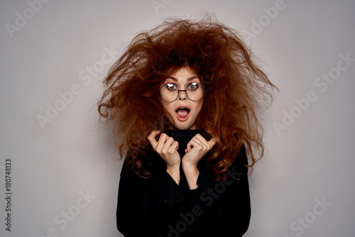 Фотография shaggy girl in glasses is surprised