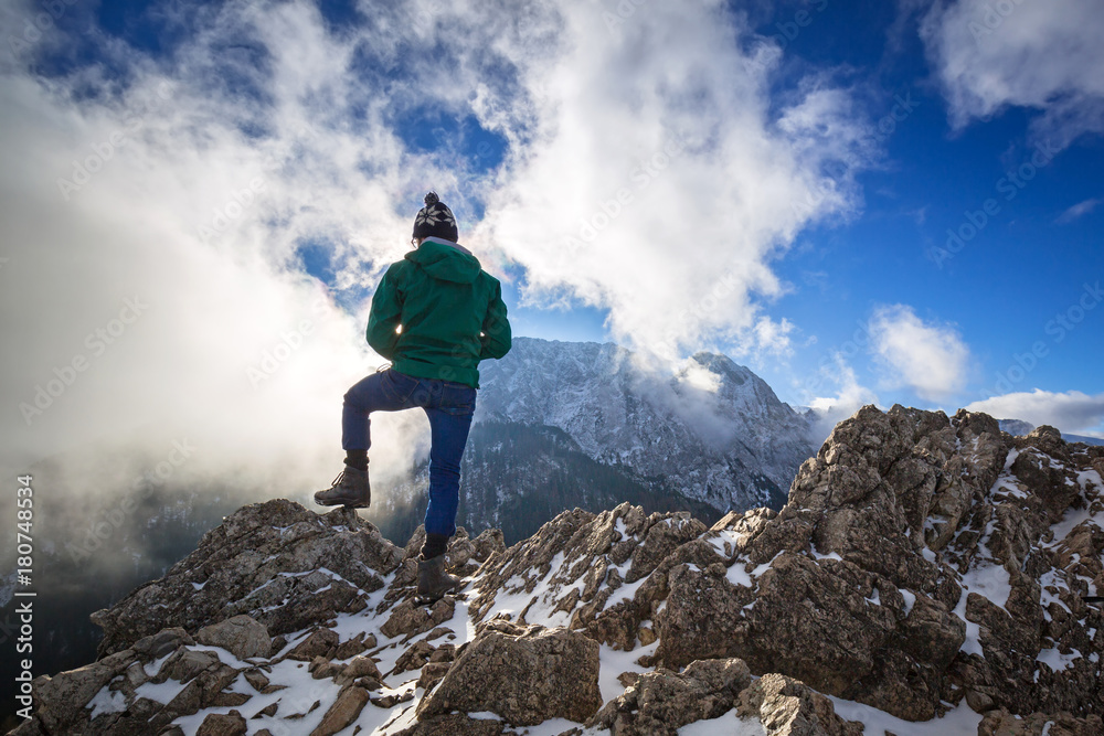 Hiker standing on the top of a hill in Tatra mountains, Poland