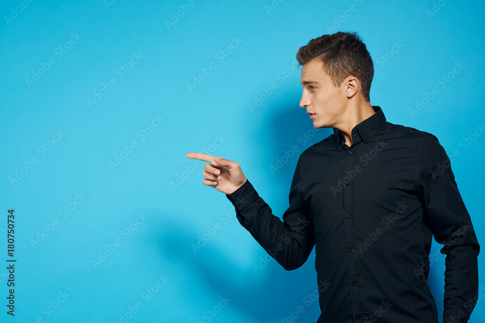 man in black shirt points finger with direction with a close look man in black shirt points finger with direction with a close look