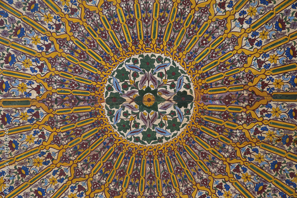 Contemplative and intricate decoration of painted wood ceiling, a technique known as zouak painting, interior of Bahia palace, Marrakesh, Morocco