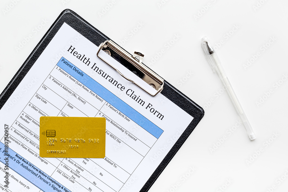 Buy health insurance. Document, pad, pen and bank card on white background top view Buy health insurance. Document, pad, pen and bank card on white background top view
