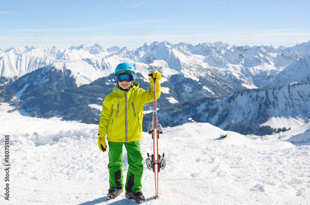 Smiling skier boy in the mountains on a sunny day. Ski,Sun, Snow and Fun.
