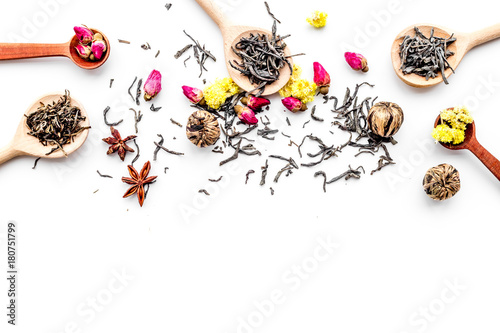Dried tea leaves near supplements like flowers and spices on white background top view pattern copyspace
