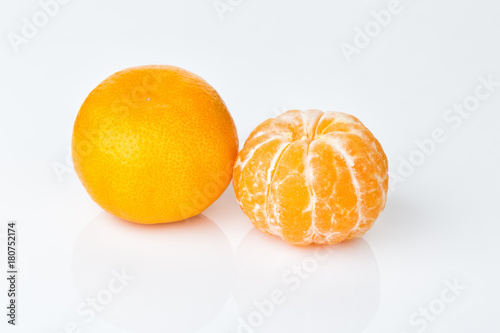 dava ripe mandarin isolated on white background, peeled and not peeled photo