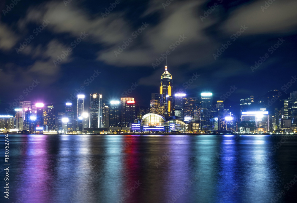 Hong Kong night building skyline with motion clouds and reflection of light Hong Kong night building skyline with motion clouds and reflection of light