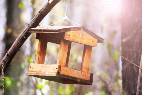 Little Birdhouse over wooden table outdoors in the garden
