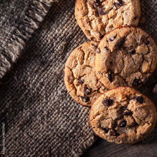 Chocolate chip cookies,  freshly baked on rustic wooden table. Selective Focus. Copy space. photo