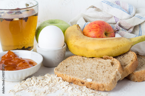 Fototapeta Naklejka Na Ścianę i Meble -  concept of healthy breakfast, tea, bread, oatmeal, eggs and fruits.