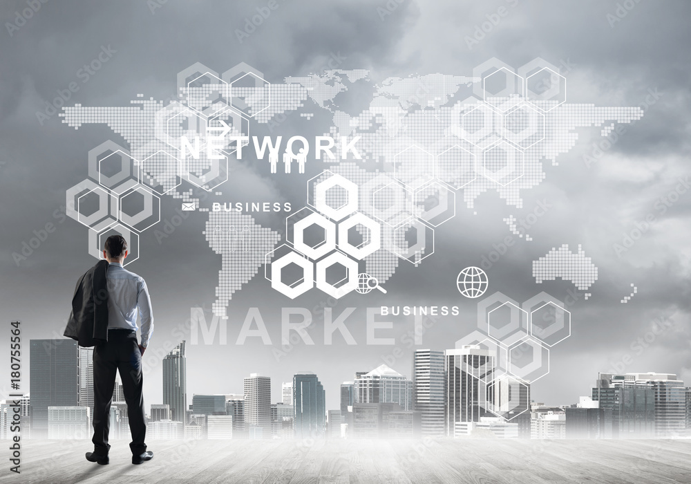 Pensive businessman looking at user interface against modern city background Pensive businessman looking at user interface against modern city background