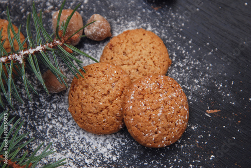 Ginger Christmas Cookies on a Black Board with Sugar Powder and Fir Branch. Cooking Recipie.