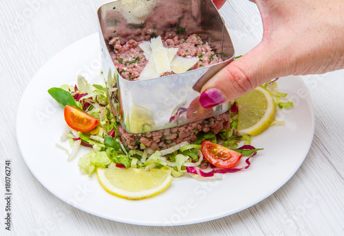 steak tartare with salad and tomatoes photo