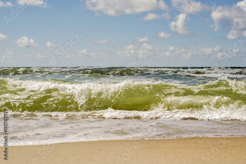 Wavy sea and cloudy sky in summer